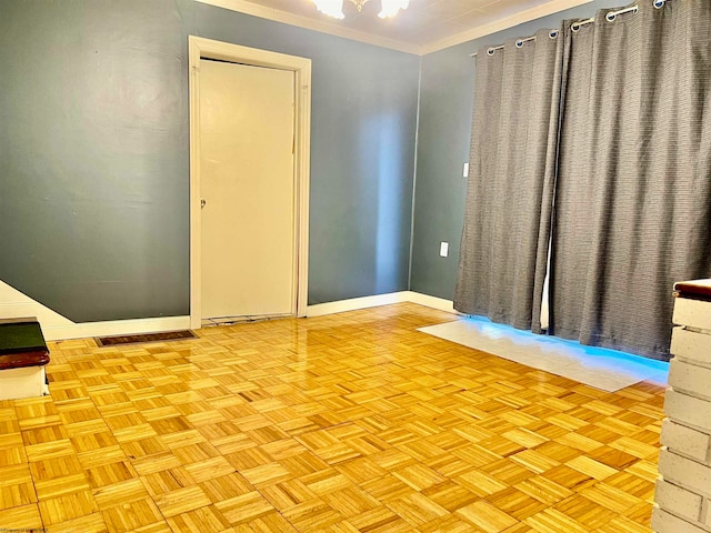 spare room featuring crown molding and light parquet floors