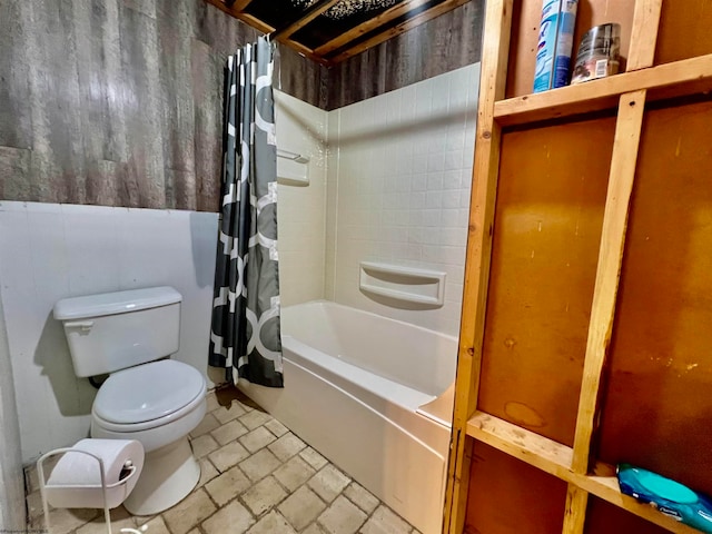 bathroom featuring toilet and shower / bathtub combination with curtain