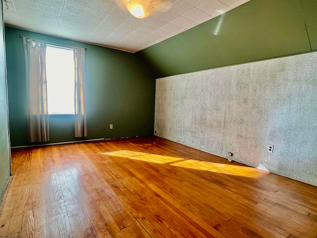 bonus room featuring wood-type flooring and lofted ceiling