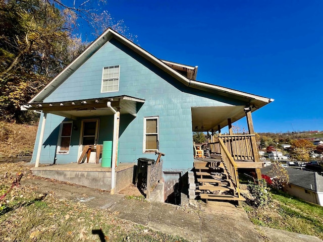 back of property with covered porch