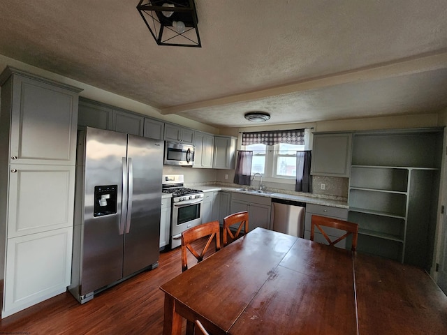 kitchen featuring gray cabinetry, appliances with stainless steel finishes, sink, and dark wood-type flooring