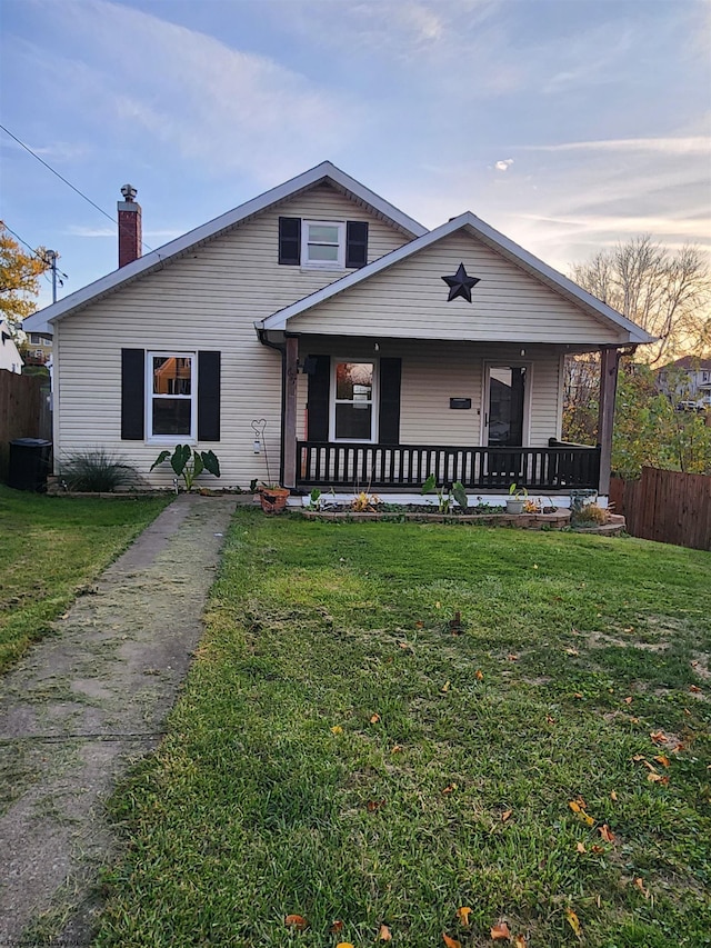 view of front facade featuring a porch and a lawn