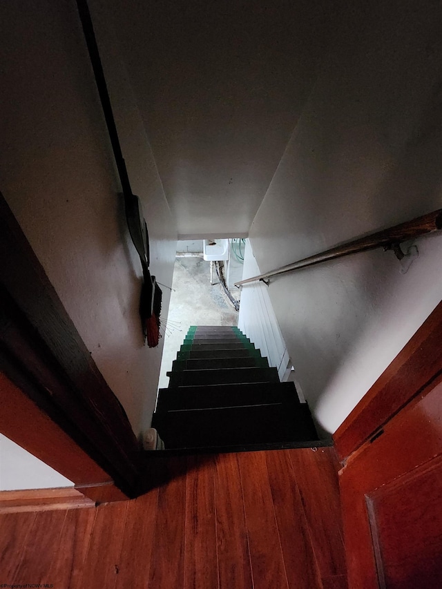 staircase with wood-type flooring