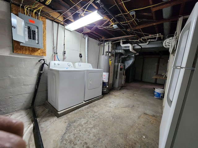 basement featuring electric panel, gas water heater, and independent washer and dryer