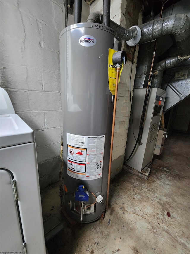 utility room with gas water heater and washer / clothes dryer