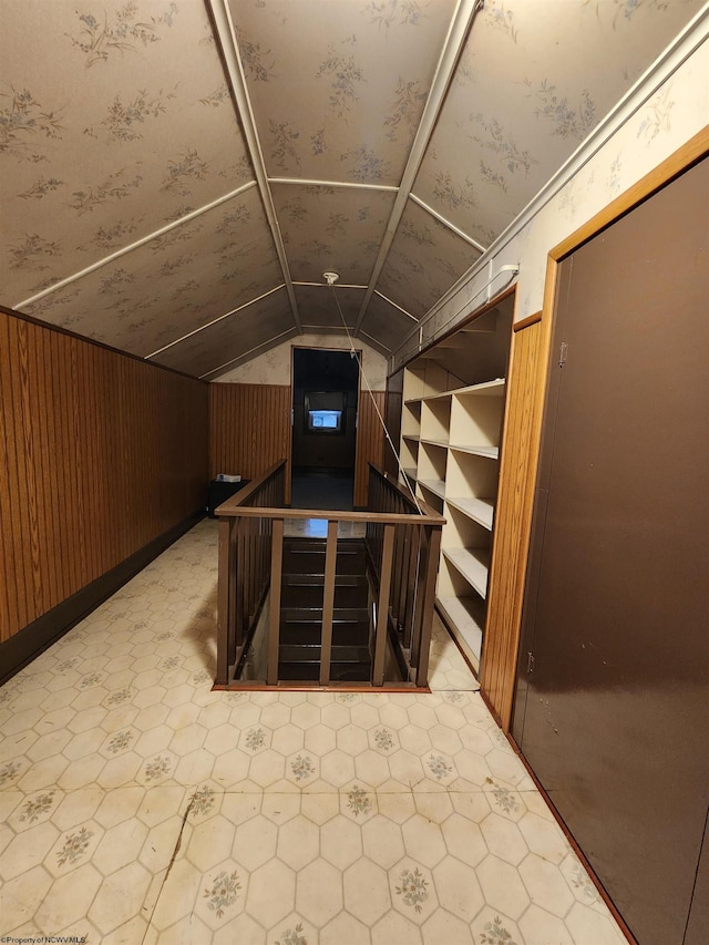 interior space featuring wooden walls and vaulted ceiling