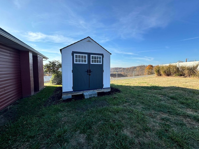 view of outbuilding with a yard