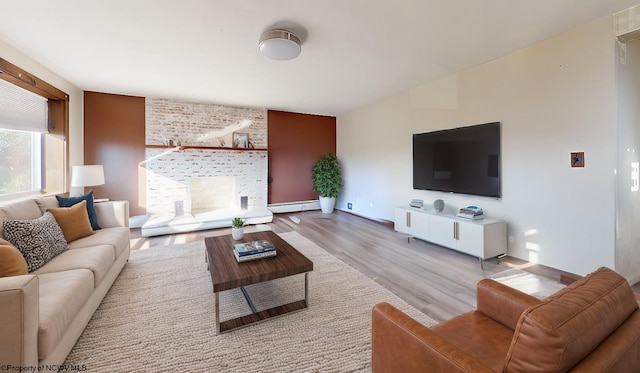 living room featuring baseboard heating and light hardwood / wood-style floors