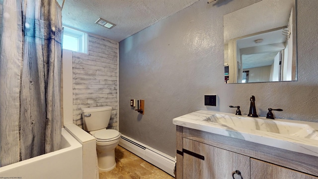 bathroom with vanity, toilet, a textured ceiling, and a baseboard heating unit