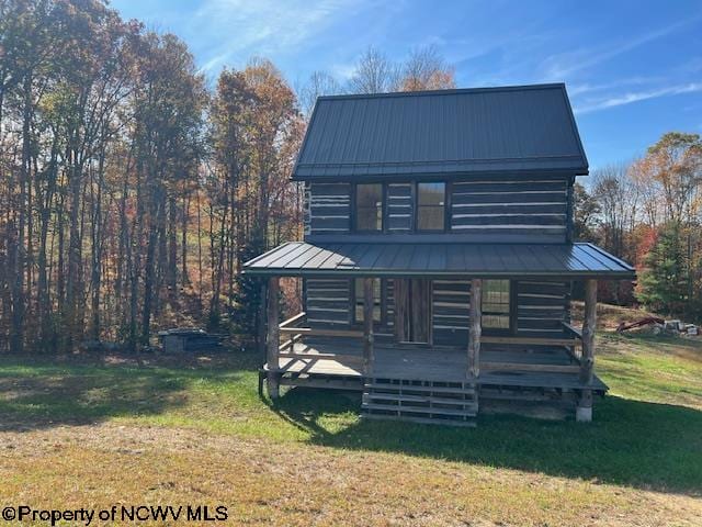 cabin with a front lawn