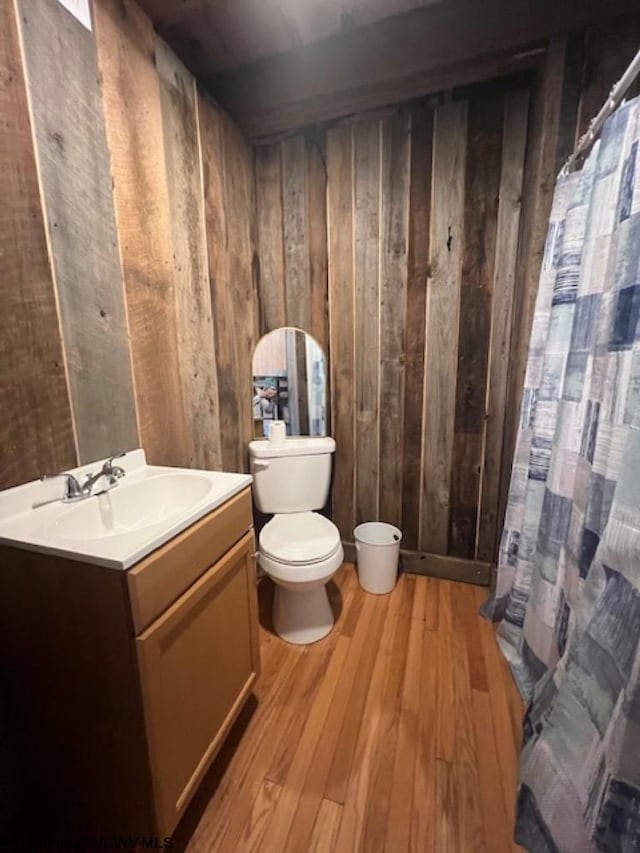 12275 Route 20 S Road, Rock Cave, WV 26234 - bathroom with wooden walls, wood finished floors, toilet, vanity, and curtained shower