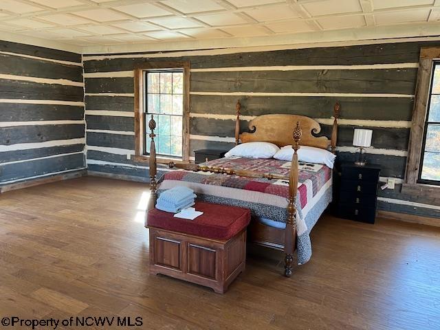 12275 Route 20 S Road, Rock Cave, WV 26234 - bedroom with wood finished floors, wooden walls, and multiple windows