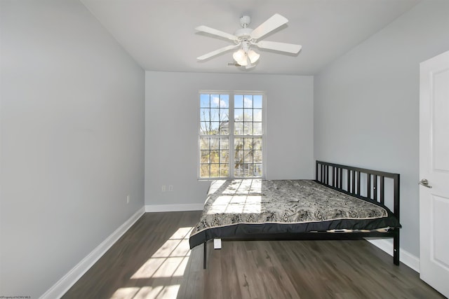 unfurnished bedroom featuring dark hardwood / wood-style flooring and ceiling fan