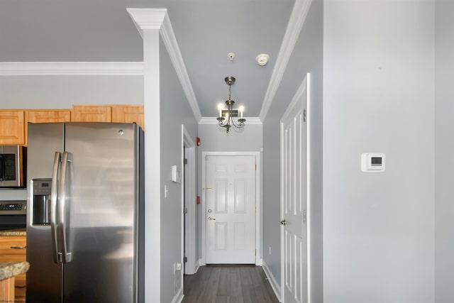 kitchen featuring light brown cabinetry, stainless steel appliances, ornamental molding, a chandelier, and dark hardwood / wood-style floors