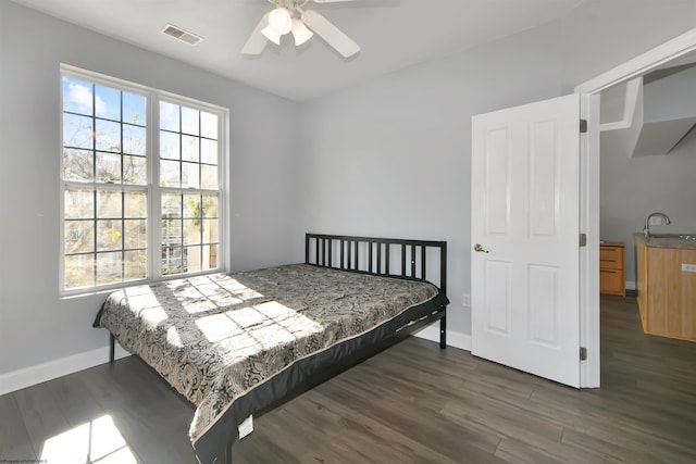 bedroom with sink, ceiling fan, and dark hardwood / wood-style flooring