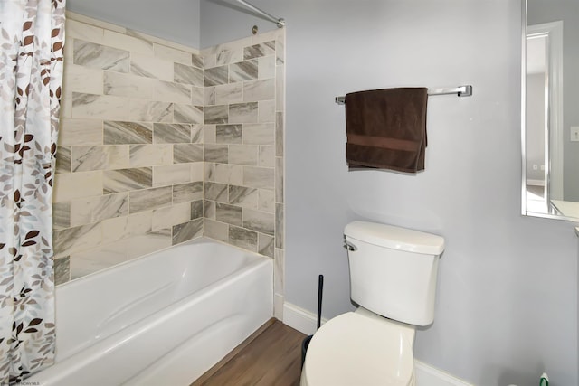 bathroom with hardwood / wood-style floors, shower / tub combo, and toilet