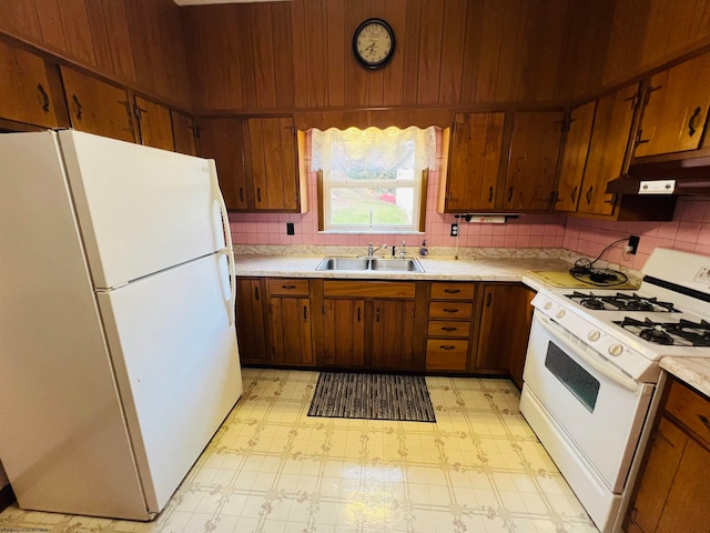 kitchen with tasteful backsplash, sink, and white appliances