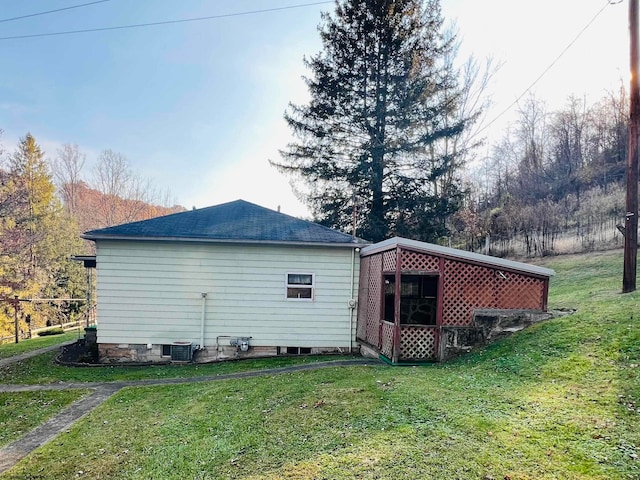 view of home's exterior featuring central AC and a lawn