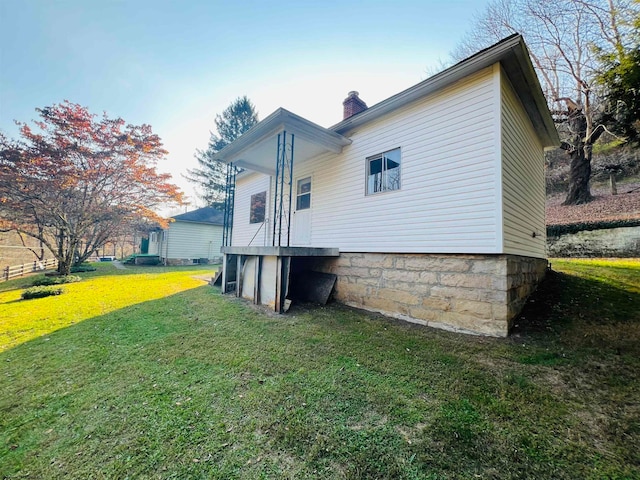 back of property featuring a lawn