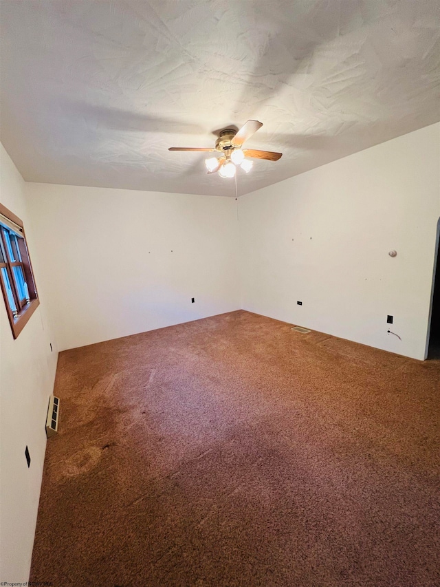 empty room with carpet floors and ceiling fan