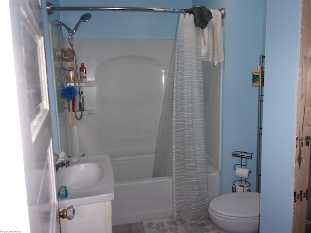 full bathroom featuring vanity, shower / bath combo, and toilet