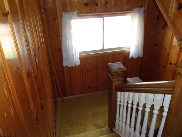 carpeted bedroom with wooden walls