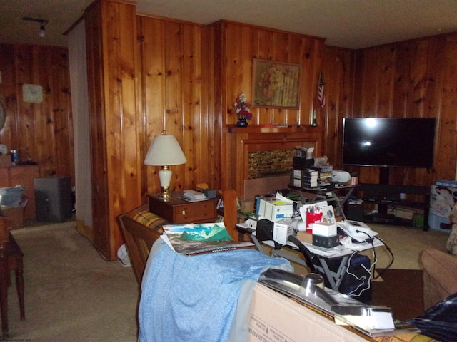 living room featuring carpet and wood walls