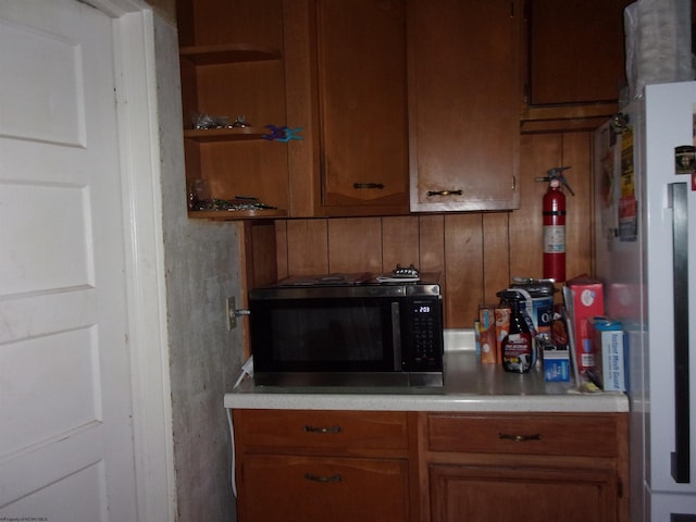 193 E Main St, Salem, WV 26426 - kitchen featuring brown cabinets, freestanding refrigerator, light countertops, and open shelves