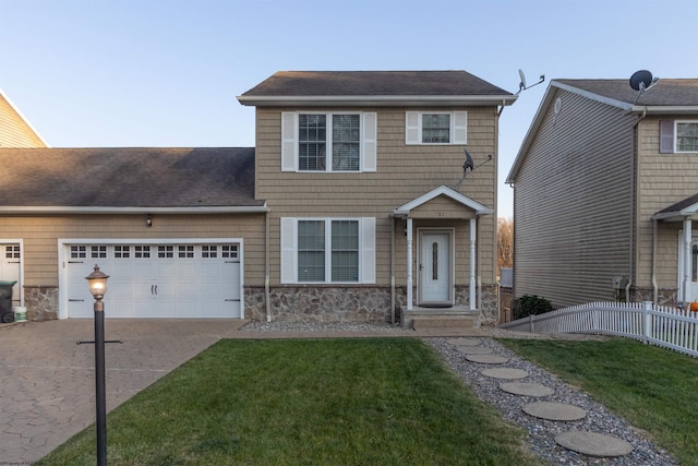 view of front of home featuring a garage and a front lawn