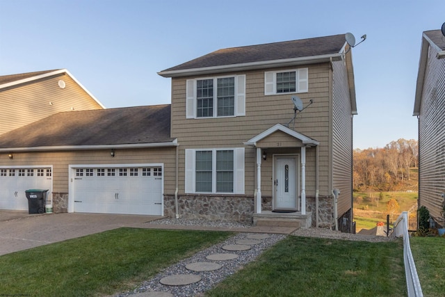 view of front facade with a front yard and a garage