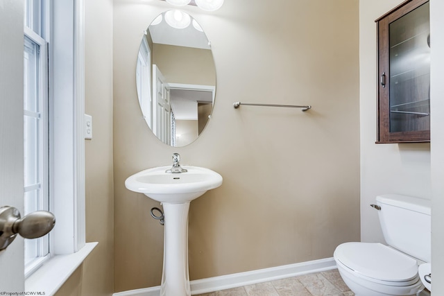 bathroom featuring toilet and tile patterned flooring