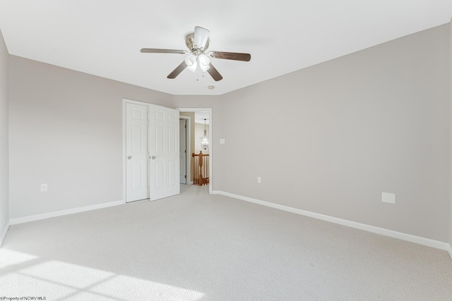 unfurnished bedroom with ceiling fan and carpet