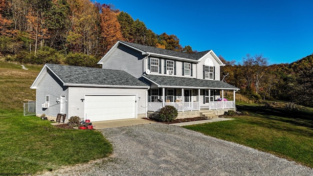 view of front of home with covered porch, a front lawn, and a garage