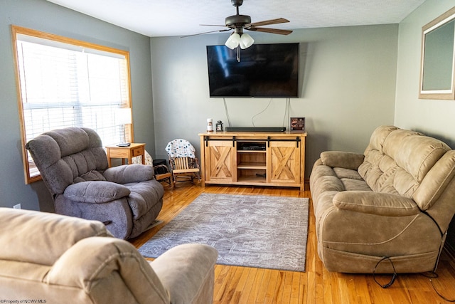 living room featuring hardwood / wood-style flooring and ceiling fan