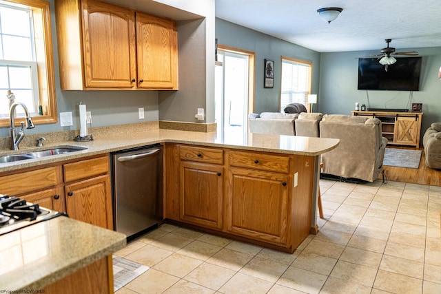 kitchen with kitchen peninsula, light tile patterned floors, ceiling fan, dishwasher, and sink