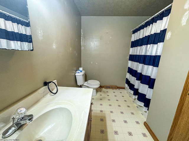 bathroom featuring vanity, toilet, a textured ceiling, and curtained shower