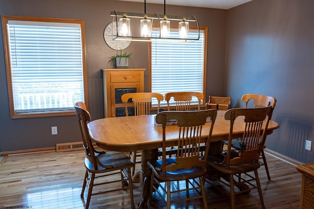 dining area with a healthy amount of sunlight and hardwood / wood-style flooring