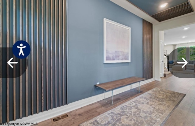 hallway featuring recessed lighting, wood finished floors, visible vents, and baseboards