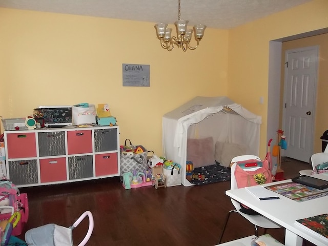 game room with hardwood / wood-style flooring and a chandelier