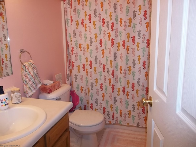 bathroom featuring vanity, toilet, and a shower with shower curtain