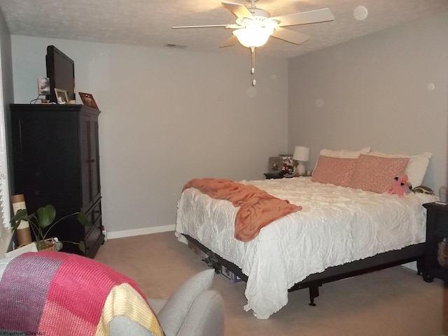 bedroom with carpet, a textured ceiling, and ceiling fan