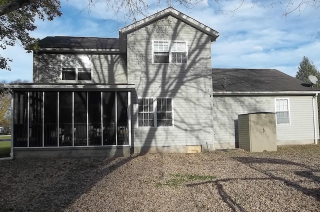 back of property with a sunroom