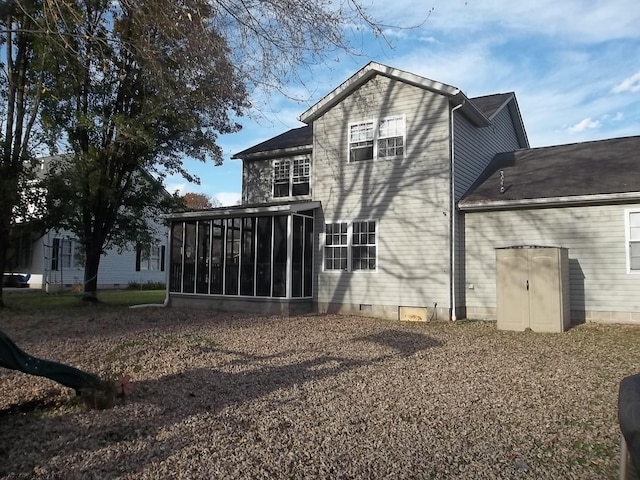 rear view of property featuring a sunroom