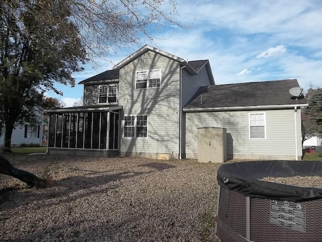 back of house featuring a sunroom