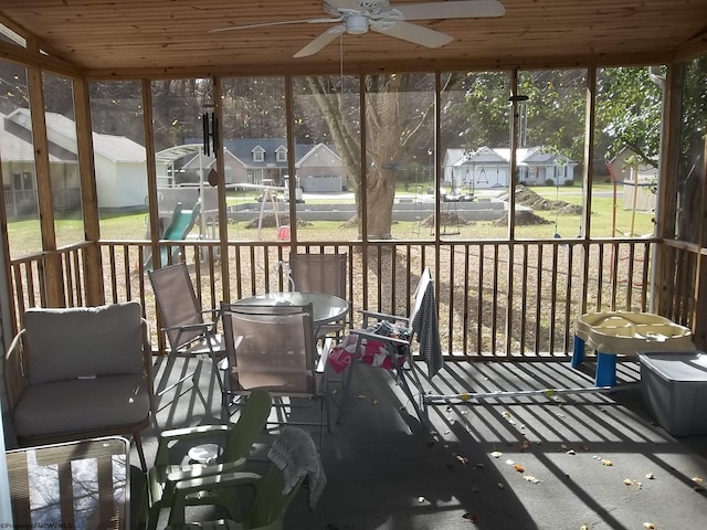 unfurnished sunroom featuring wooden ceiling and ceiling fan