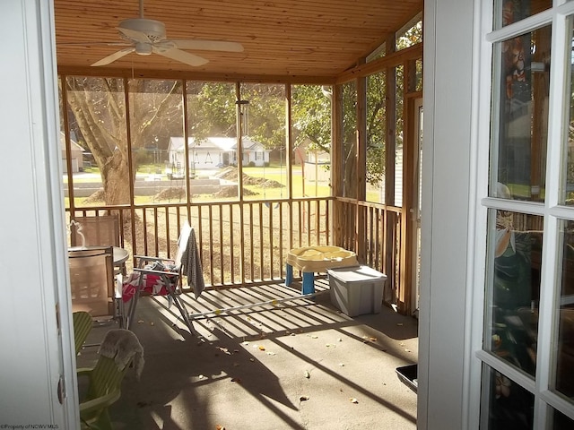 sunroom / solarium with wood ceiling, ceiling fan, and plenty of natural light