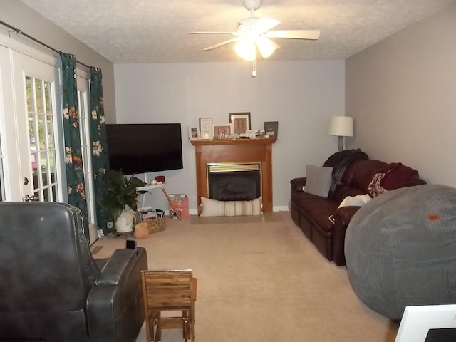 carpeted living room with a textured ceiling and ceiling fan