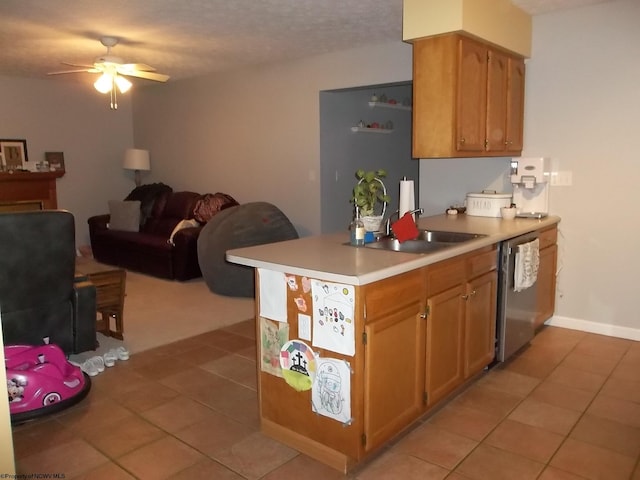 kitchen featuring sink, light tile patterned floors, stainless steel dishwasher, a textured ceiling, and ceiling fan