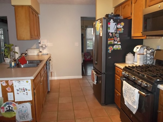 kitchen featuring sink, appliances with stainless steel finishes, and light tile patterned floors