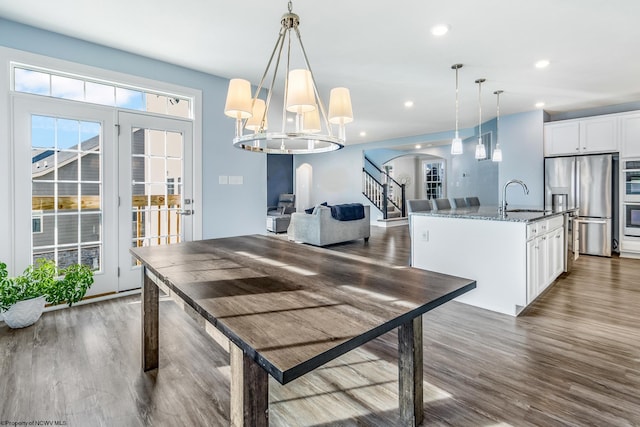 dining room with sink and dark hardwood / wood-style flooring